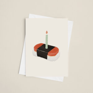 Spam musubi with a candle stuck on top as if it was a birthday cake