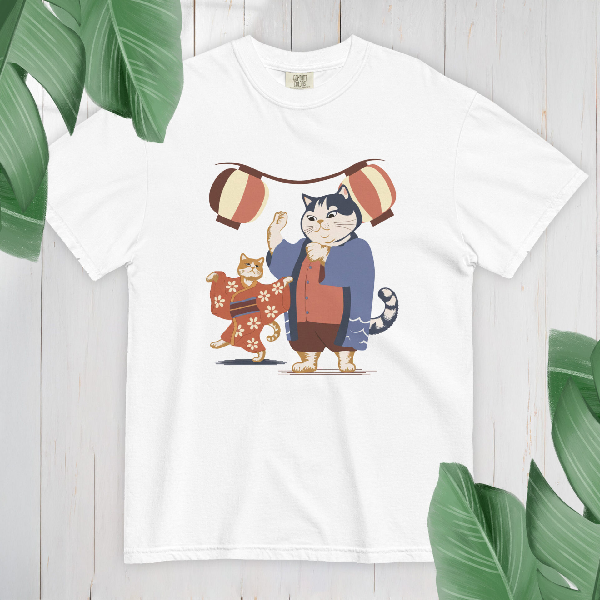 Cartoon cats in happi coats dancing under lanterns for Obon on a tan organic cotton tote